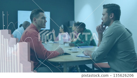 Professional team discussing plans in glass room around conference table, with coffee cups, tablet Professional team discussing plans in glass room around conference table, with coffee cups, tablet 135626206