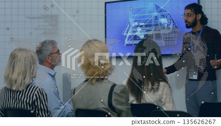Presenting Indian presenter gesturing at blueprint screen with map overlay in boardroom, copy space 135626267