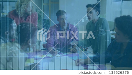 Team members discussing plan at conference table, pointing at charts and using markers for analysis Team members discussing plan at conference table, pointing at charts and using markers for analysis 135626276