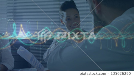 Colleagues discussing report with charts in conference room, waveform overlay above paper cup Colleagues discussing report with charts in conference room, waveform overlay above paper cup 135626290