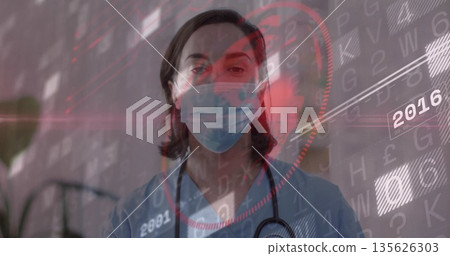 Standing doctor wearing blue scrubs and mask inside clinic, showing stethoscope with data overlay Standing doctor wearing blue scrubs and mask inside clinic, showing stethoscope with data overlay 135626303