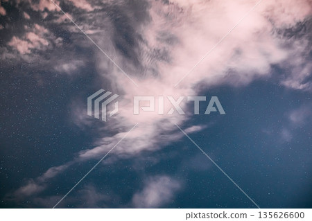 Real Night Sky Stars with some clouds cloudy sky. Natural Starry Sky Blue Color Background. unusual view natural background Real Night Sky Stars with some clouds cloudy sky. Natural Starry Sky Blue Color Background. unusual view natural background 135626600