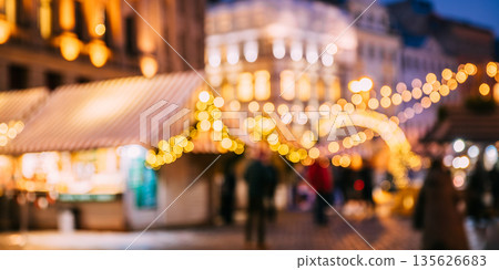 Abstract Blurred Bokeh Boke Background Of Traditional Christmas Market In Night European Town. Evening Street Decorated With Festive Christmas Xmas New Year Illuminations 135626683