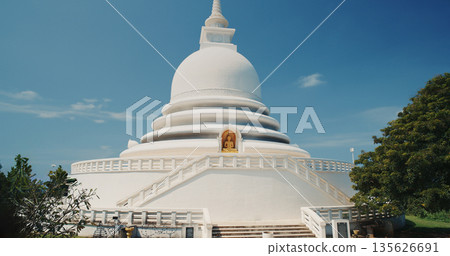 Japanese Peace Pagoda in Unawatuna Sri Lanka with Golden Buddha Statue 135626691