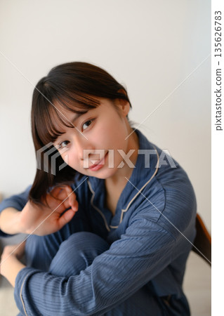 A woman relaxing in her pajamas A woman relaxing in her pajamas 135626783
