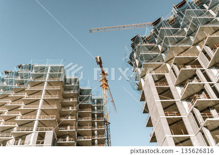 Construction of a building. Construction site with crane. Business, development, industry. 135626816