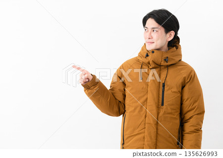 Young man wearing a down coat 135626993