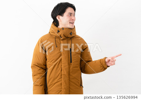 Young man wearing a down coat 135626994