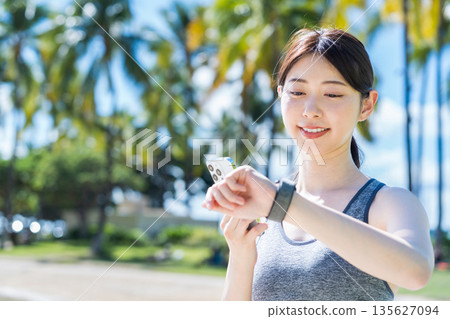 Young woman jogging at a resort 135627094