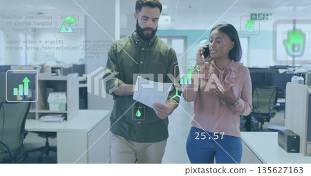 Walking coworkers in office attire analyzing digital data in office with printed papers smartphone Walking coworkers in office attire analyzing digital data in office with printed papers smartphone 135627163