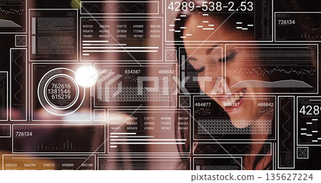 Smiling Chinese woman leaning toward floating data panels with light flare at tech hub, copy space Smiling Chinese woman leaning toward floating data panels with light flare at tech hub, copy space 135627224