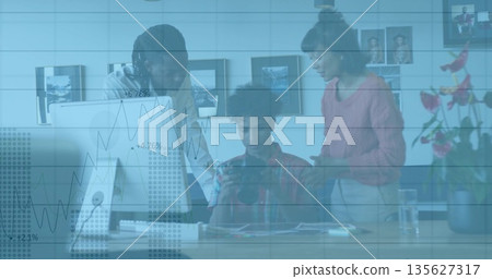 Collaborating colleagues analyzing data on tablet at modern office desk, with desktop monitor Collaborating colleagues analyzing data on tablet at modern office desk, with desktop monitor 135627317