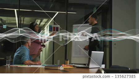 Three professionals discussing design pitch in meeting room, with flip chart and color board Three professionals discussing design pitch in meeting room, with flip chart and color board 135627385