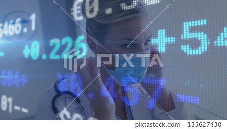 Securing blue surgical mask on nurse in hospital corridor with stethoscope and stock ticker symbols Securing blue surgical mask on nurse in hospital corridor with stethoscope and stock ticker symbols 135627430