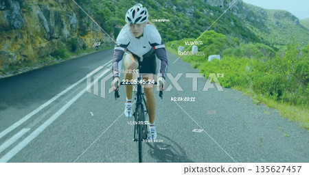 Pedaling cyclist wearing white and lavender jacket riding mountain road, with digital data overlays Pedaling cyclist wearing white and lavender jacket riding mountain road, with digital data overlays 135627457