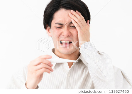 Young man wearing a long-sleeved white shirt Young man wearing a long-sleeved white shirt 135627460