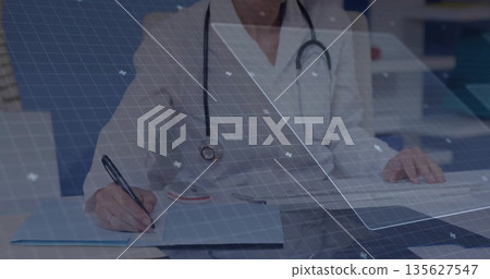 Female physician wearing lab coat, stethoscope, writing on clipboard in clinical office, with pen Female physician wearing lab coat, stethoscope, writing on clipboard in clinical office, with pen 135627547