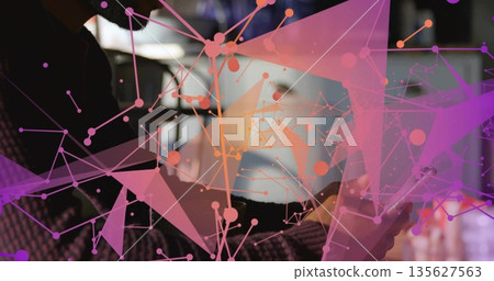 Holding smartphone, African American man working at modern workspace, with digital network overlay 135627563