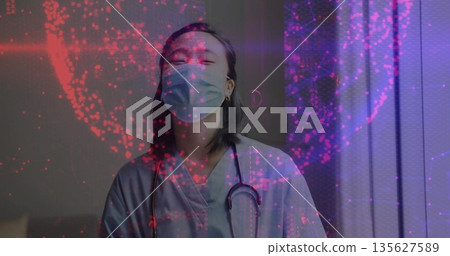 Standing nurse wearing blue scrubs, stethoscope and mask in clinic, with digital network overlay 135627589