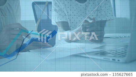 Pointing white-coated doctor with stethoscope at charts with pen in clinic, with patient and laptop 135627665