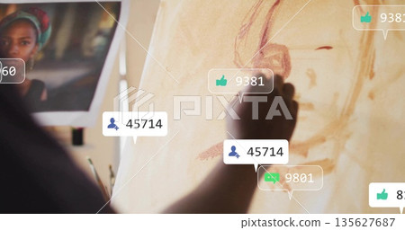 African American male sketching portrait on canvas in studio, with print, social icons, copy space 135627687