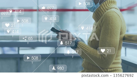 Woman in yellow sweater scrolling smartphone at terminal railing, window, with icons, copy space Woman in yellow sweater scrolling smartphone at terminal railing, window, with icons, copy space 135627692
