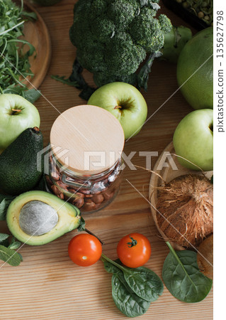 A vibrant collection of fresh fruits and vegetables arranged on a wooden surface, showcasing a healthy and natural lifestyle A vibrant collection of fresh fruits and vegetables arranged on a wooden surface, showcasing a healthy and natural lifestyle 135627798