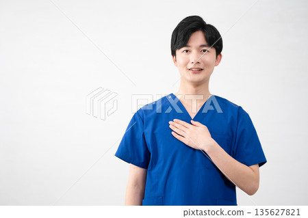 A young man wearing medical scrubs A young man wearing medical scrubs 135627821