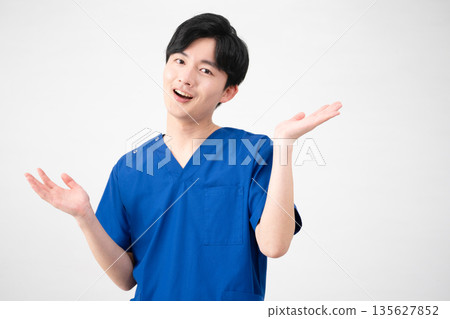 A young man wearing medical scrubs A young man wearing medical scrubs 135627852