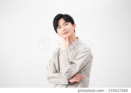 Young man wearing a long-sleeved shirt Lifestyle image Young man wearing a long-sleeved shirt Lifestyle image 135627880