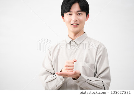 Young man wearing a long-sleeved shirt Lifestyle image Young man wearing a long-sleeved shirt Lifestyle image 135627881