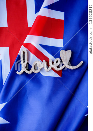 Wooden word LOVE on background of National symbol of Australia flag background. Copy space for your text. Concept Wooden word LOVE on background of National symbol of Australia flag background. Copy space for your text. Concept 135628212
