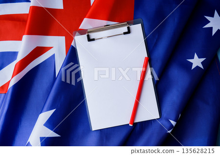 White empty paper copy space template mock up Australian flag background. National symbol and patriotism concept, ideal mock-up for custom copy designs. Place your logo or text on the white paper White empty paper copy space template mock up Australian flag background. National symbol and patriotism concept, ideal mock-up for custom copy designs. Place your logo or text on the white paper 135628215