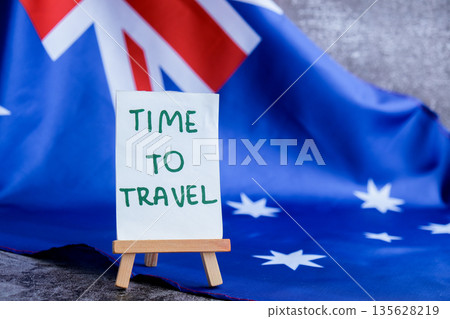 Australian flag and text TIME TO TRAVEL perfect for tourism or vacation advertising. Concept of wanderlust and national adventure use in travel guides Australian flag and text TIME TO TRAVEL perfect for tourism or vacation advertising. Concept of wanderlust and national adventure use in travel guides 135628219