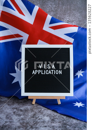 Text VISA APPLICATION on background of waving Australian flag made from silk. Concept of tourism and traveling. Inviting greeting card, advertisement 135628227