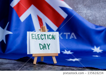 Australian flag with message text ELECTION DAY for political coverage. Patriotic signage and flag for voter outreach or campaign branding. Concept of democracy and civic duty suitable for voter 135628234