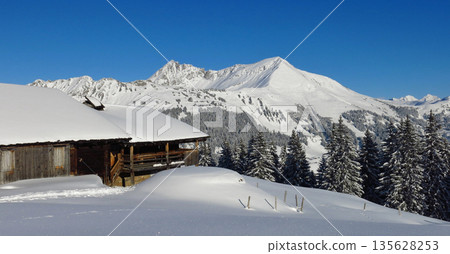 Old timber farmhouse and mountains Gifer and Lauenehore in winter, view from Wispile, Gstaad. Old timber farmhouse and mountains Gifer and Lauenehore in winter, view from Wispile, Gstaad. 135628253