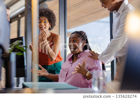 In office, colleagues celebrating success, showing joy and enthusiasm together 135628274