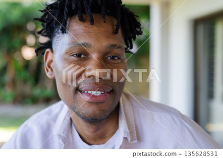 Smiling man enjoying outdoor time, relaxing in casual shirt, feeling happy Smiling man enjoying outdoor time, relaxing in casual shirt, feeling happy 135628531