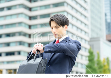 An office district with roadside trees and a man in a suit 135629435