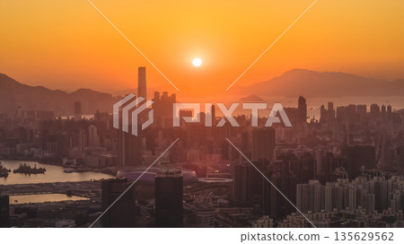 Jan 11 2026 Kowloon skyline glowing under warm golden sunset light 135629562
