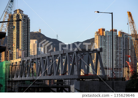 Sept 14 2025 Urban Bridge Construction With Cityscape and Mountain Background Sept 14 2025 Urban Bridge Construction With Cityscape and Mountain Background 135629646