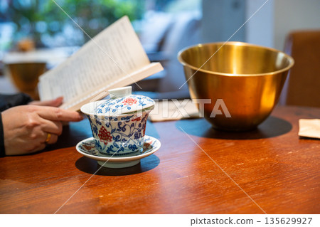 Enjoying tea and reading in a cafe in Chengdu Sichuan China 135629927
