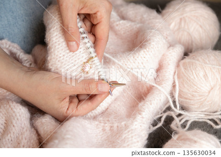 Cozy handmade knitting with wool yarn and needles representing comfort creativity and home hobby Cozy handmade knitting with wool yarn and needles representing comfort creativity and home hobby 135630034