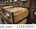 Wooden filing cabinet with open drawer displaying organized index cards and labels for reference 135630041