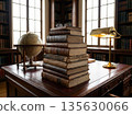 Stacked antique books on wooden desk with globe and lamp in classic library interior 135630066