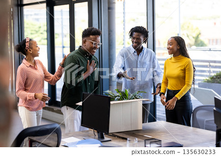 Diverse team in office celebrating success with smiles and positive energy 135630233