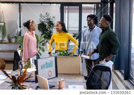 Team discussing new project ideas in modern office, surrounded by plants 135630261