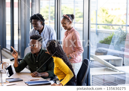 Team collaborating on project in modern office, discussing ideas with enthusiasm Team collaborating on project in modern office, discussing ideas with enthusiasm 135630275