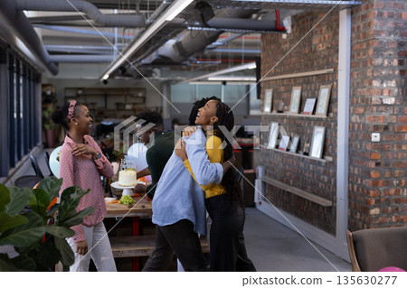 Colleagues celebrating birthday in modern office, sharing laughter and joy 135630277